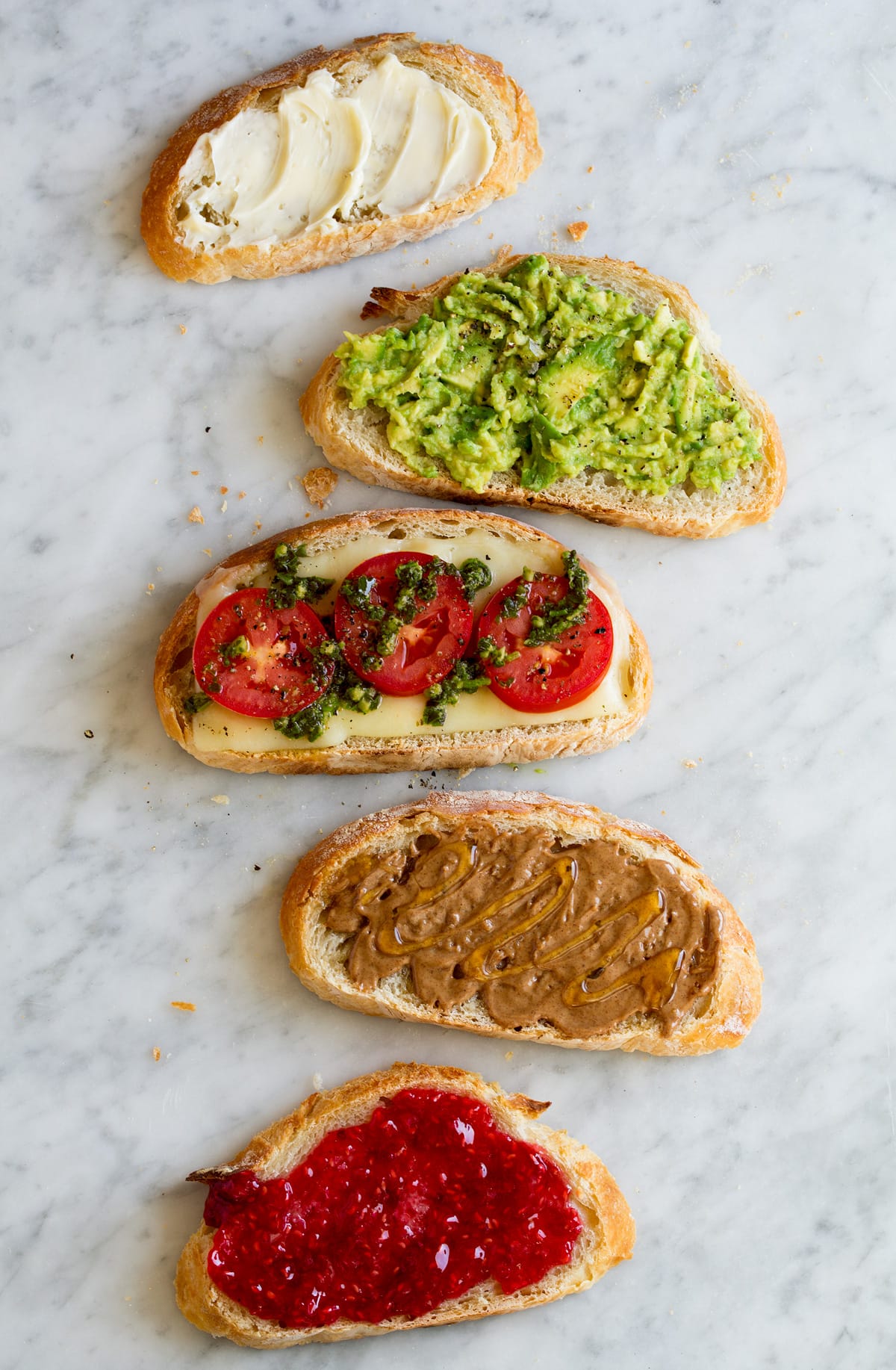 Different toppings ideas shown on slices of no knead bread.