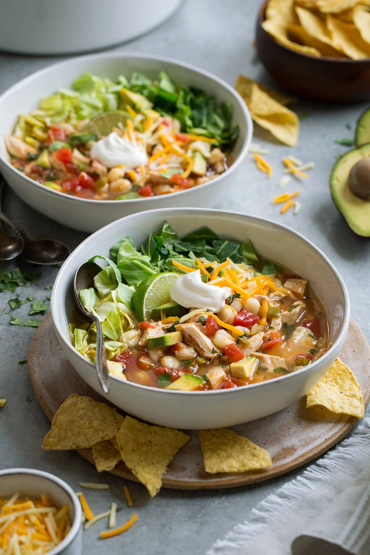 Two servings of chicken posole in serving bowls.