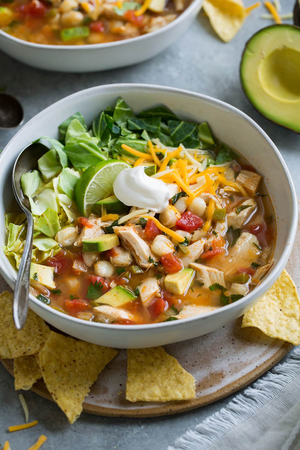 Chicken Pozole in a single serve bowl set over a plate.