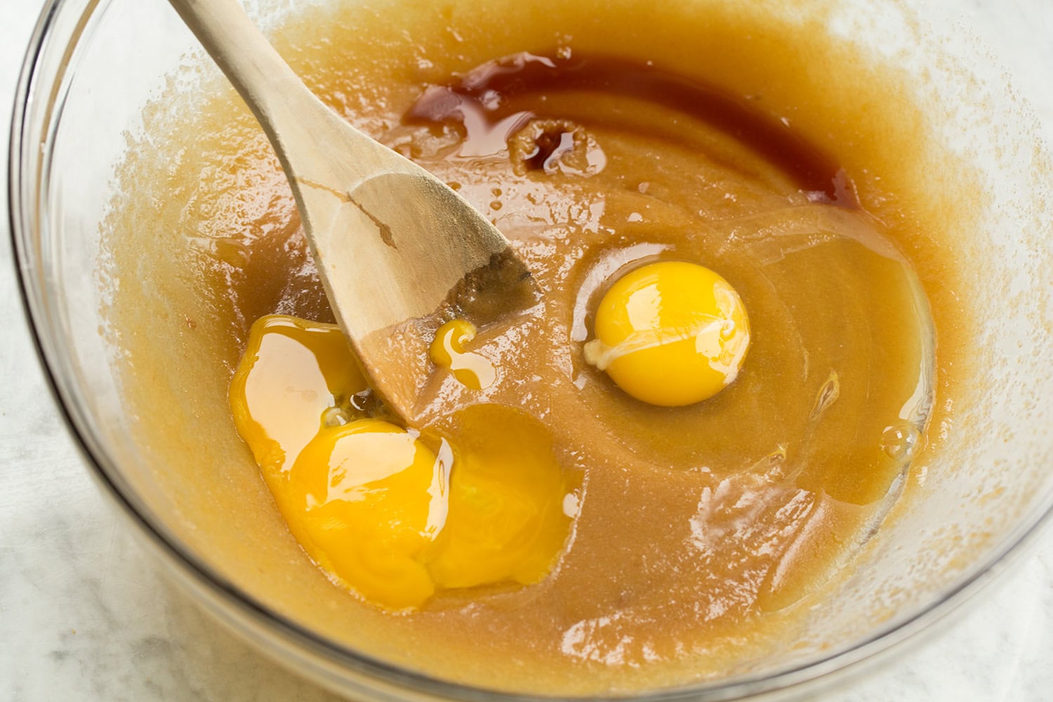 Eggs and vanilla added to sugar butter cookie mixture.