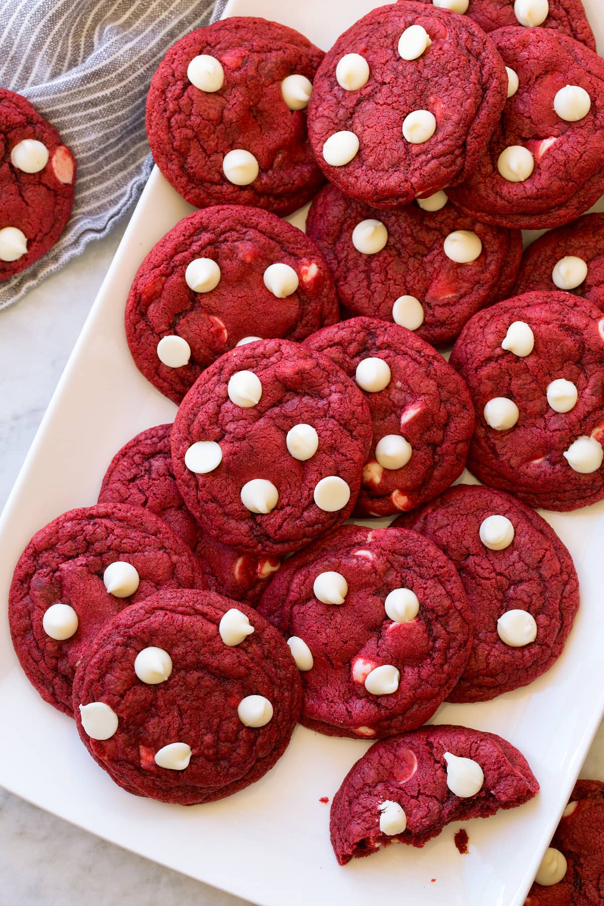Red Velvet Cookies shown from overhead on a rectangular white platter on a marble surface.