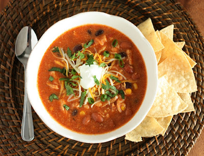 Slow Cooker Chicken Enchilada Soup topped with cheese and sour cream