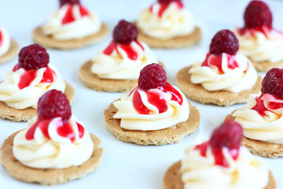 Mini Cheesecakes topped with fresh raspberries
