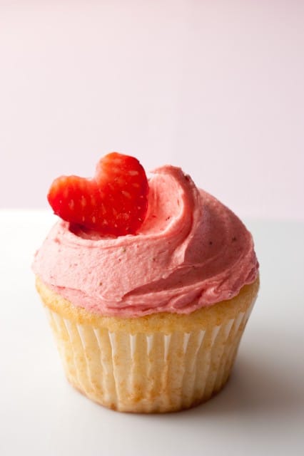 Strawberry Shortcake Cupcake topped with strawberry buttercream and sliced fresh strawberry 