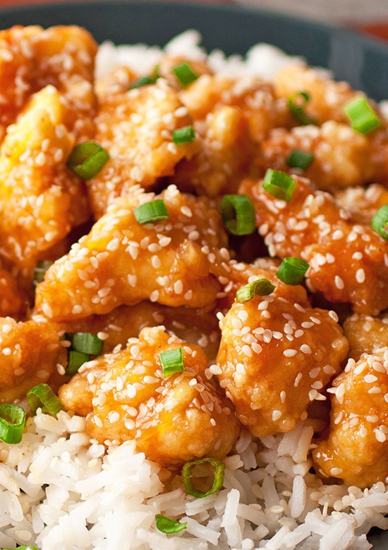 close up of Honey Sesame Chicken garnished with sesame seeds and green onions