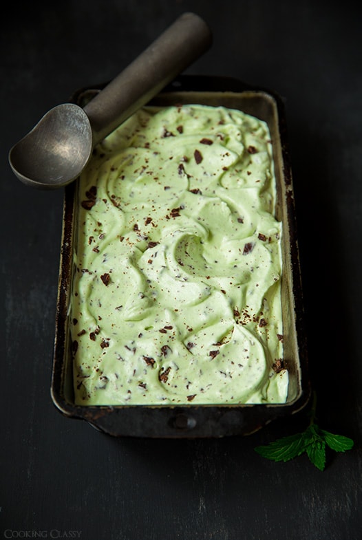 homemade Mint Chocolate Chip Ice Cream in bread pan with ice cream scoop