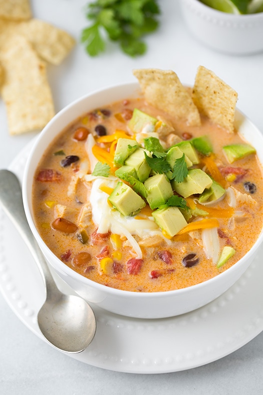 Creamy Chicken Tortilla Soup in a white bowl with a spoon