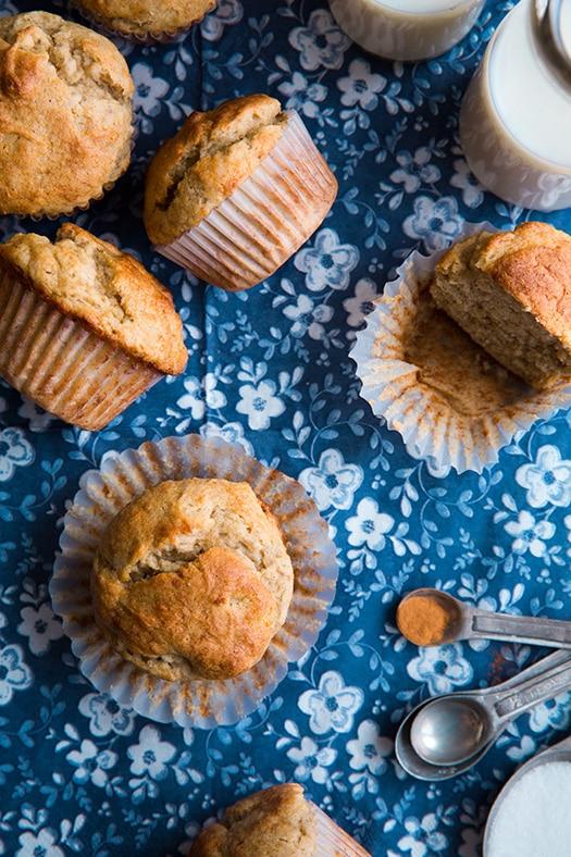 five gluten free banana muffins on blue patterned table cloth