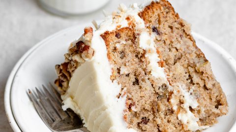 Single slice of homemade hummingbird cake on a white dessert plate.