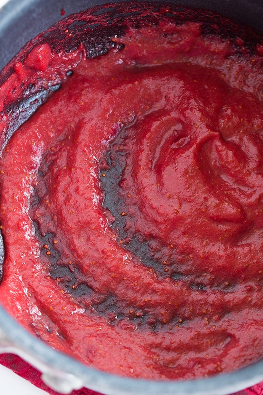 making strawberry reduction in a pan