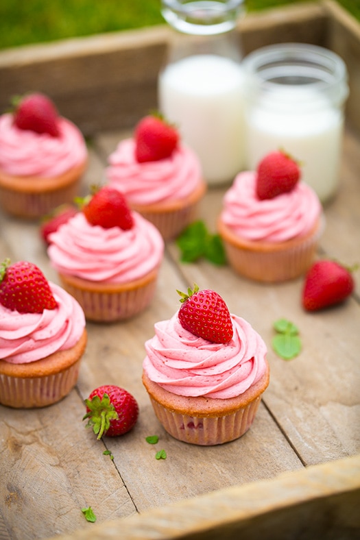 Strawberry cupcakes on a wooden tray