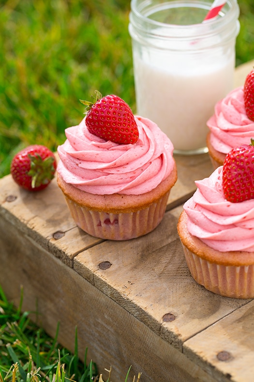 Strawberry Cupcakes on a wooden tray with a glass of milk