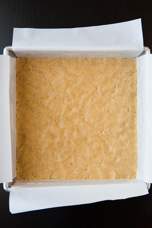 unbaked graham cracker crust in a square baking dish