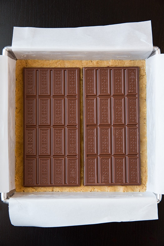 hershey chocolate bars atop unbaked graham cracker crust