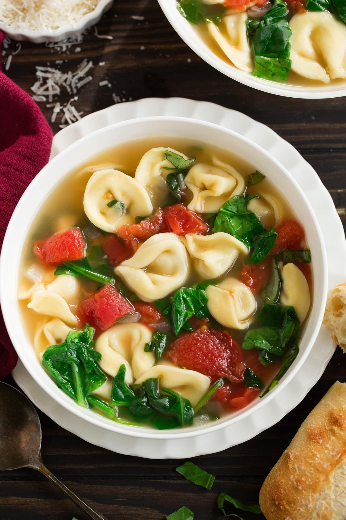 Overhead image of tortellini soup in a white serving bowl.