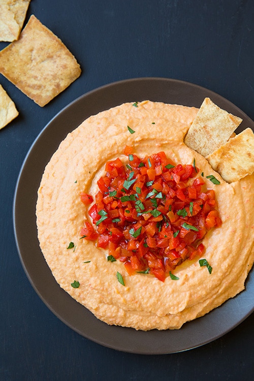Roasted Red Pepper Hummus in gray bowl with pita chips