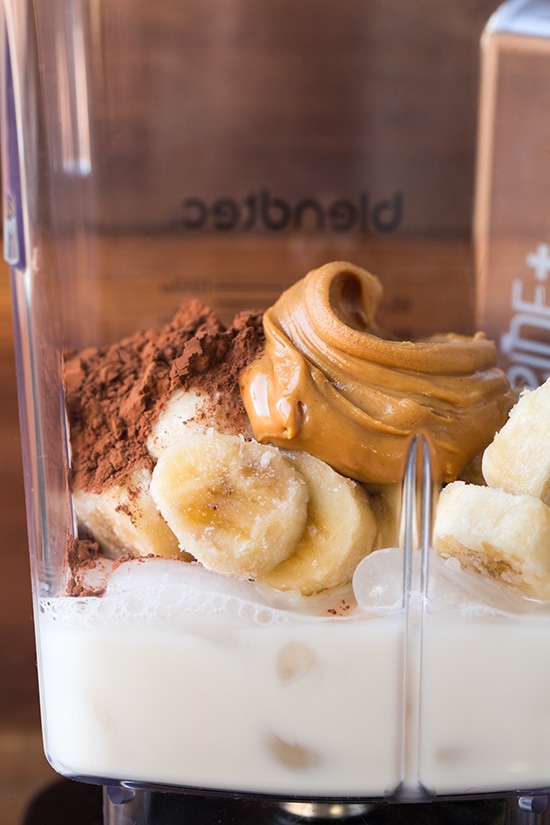Ingredients for a chocolate banana shake in a blender