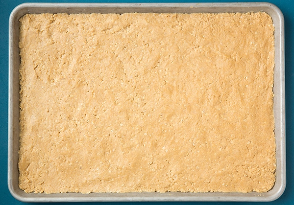 Peanut butter bars on a baking sheet before baking.