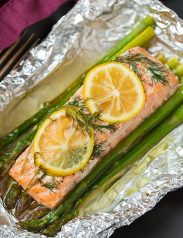 A close up of salmon and asparagus in foil
