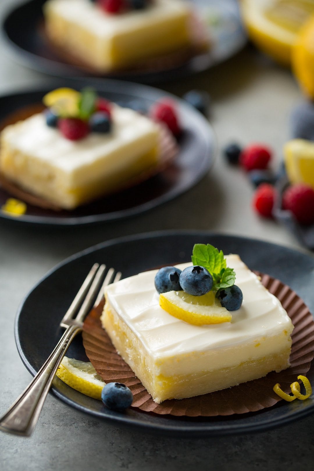 lemon cream cheese bar on plate with a fork