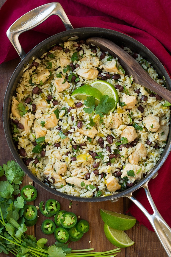 One Pan Cilantro Lime Chicken and Rice with Black Beans in a skillet topped with lime
