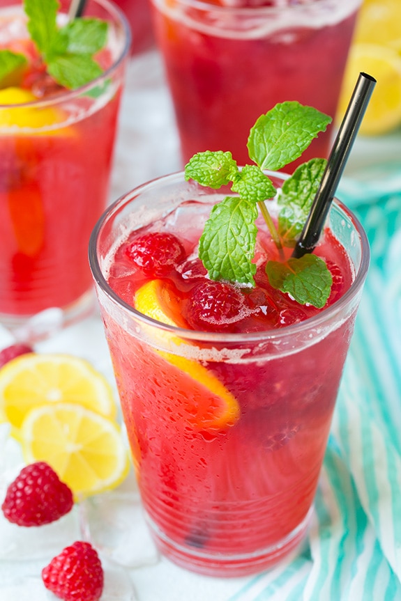glass of Sparkling Raspberry Lemonade garnished with fresh mint