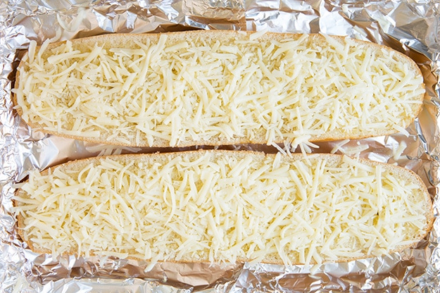 uncooked Cheesy Garlic Bread on foil