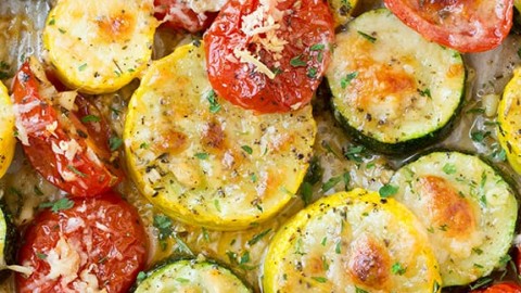 A close up of roasted zucchini and other veg on a roasting pan