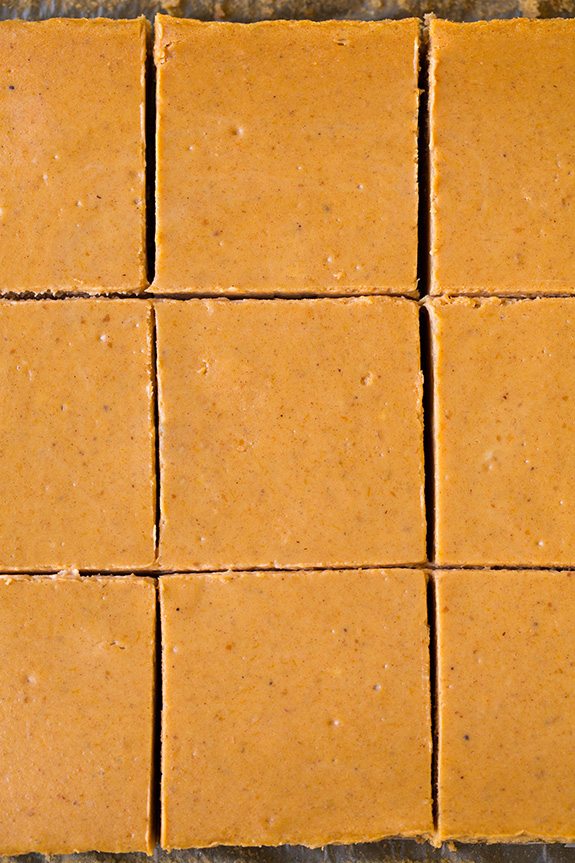 Overhead image of sliced pumpkin cheesecake bars without toppings.