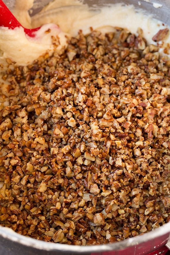 Chopped pecans added to butter pecan cake batter in mixing bowl.