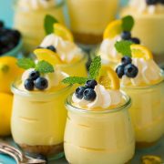 Lemon mousse in glass jars with whipped cream