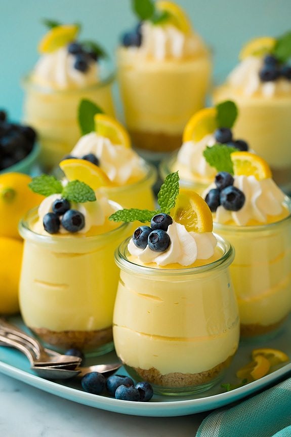Lemon mousse in individual glasses topped with whipped cream