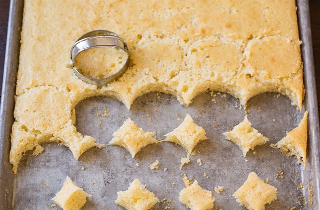cutting cake with biscuit cutter in pan