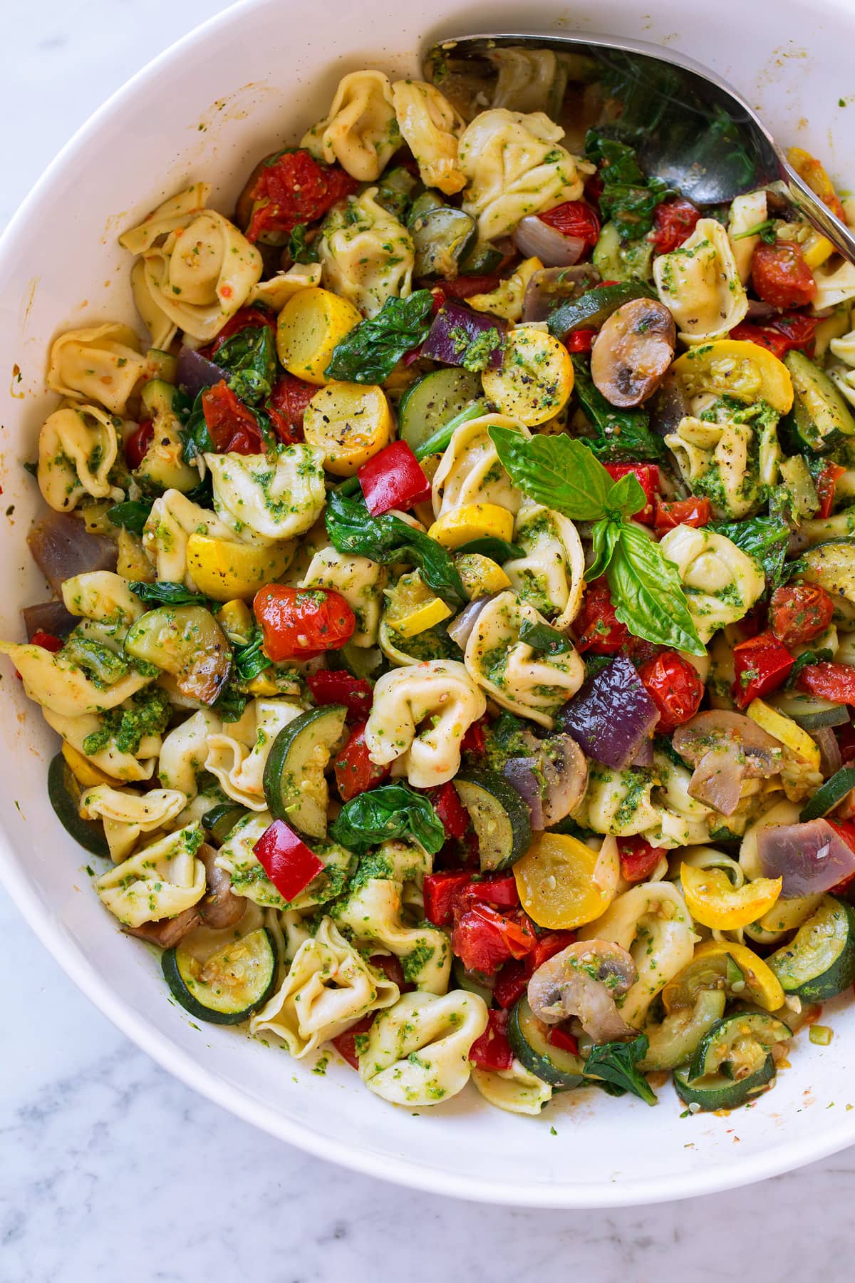 Cheese tortellini with pesto and roasted vegetables.