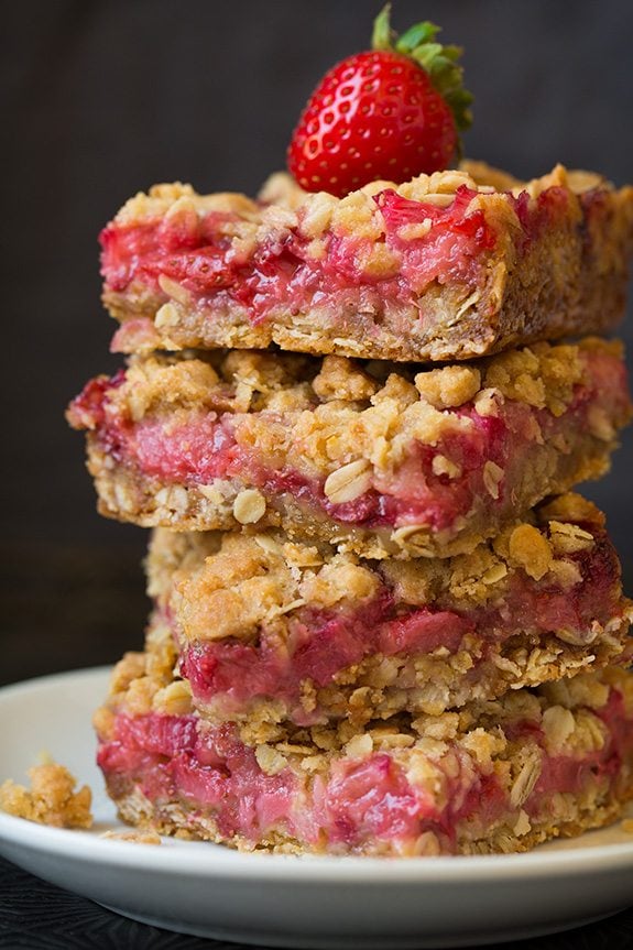 stack of four Strawberry Rhubarb Bars on a white plate