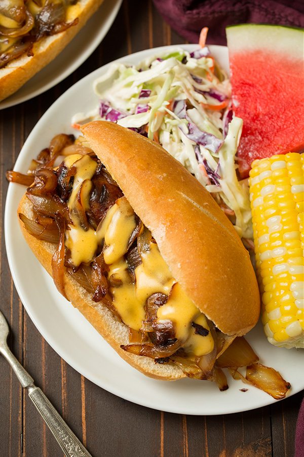 Brats with caramelized onions and cheddar cheese sauce