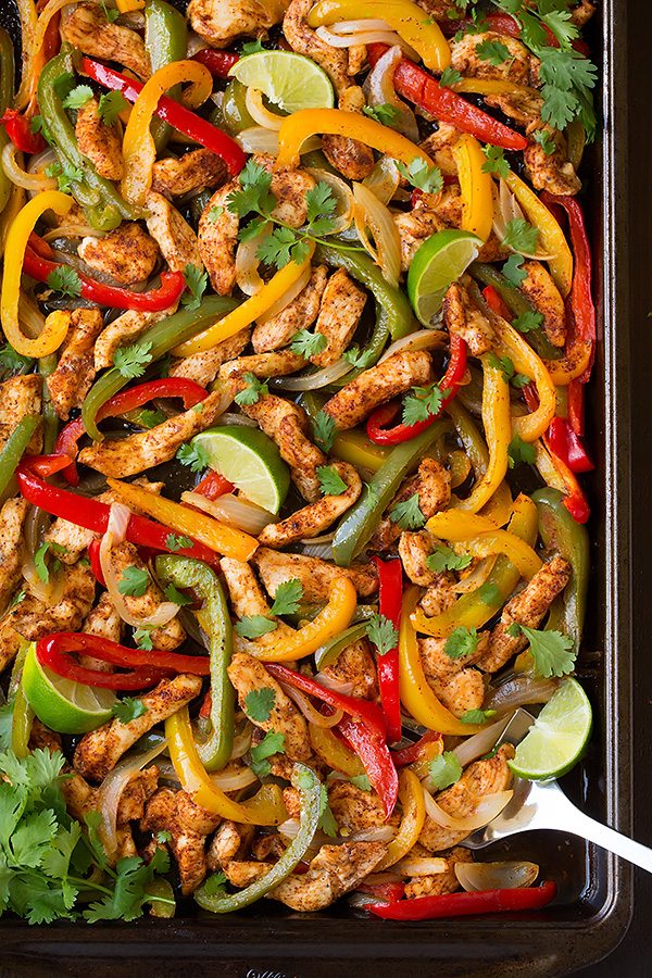 Chicken Fajitas on baking sheet with cilantro and limes 