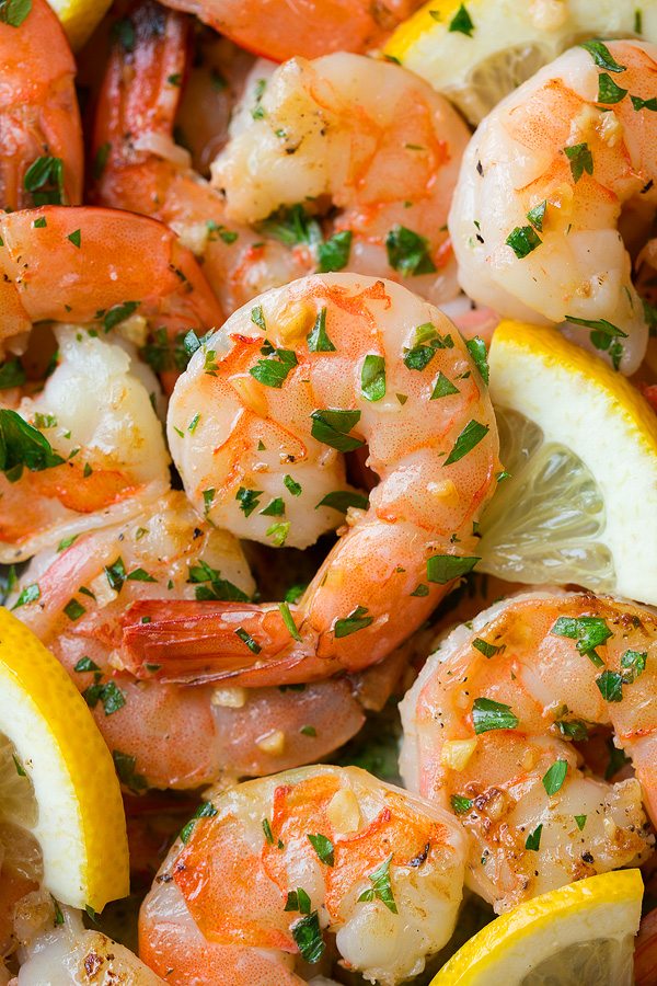 Close up image of cooked shrimp with garlic, lemon and butter.