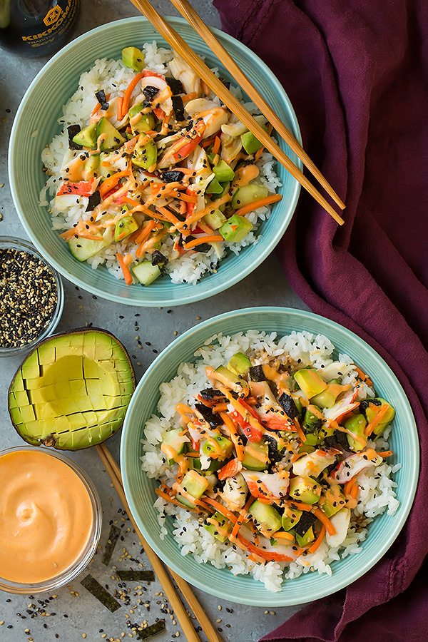 Two deconstructed California rolls in bowls.