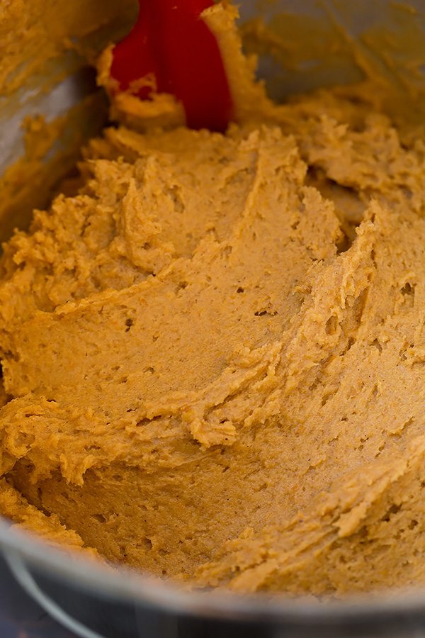 Pumpkin cookie batter in a mixing bowl.