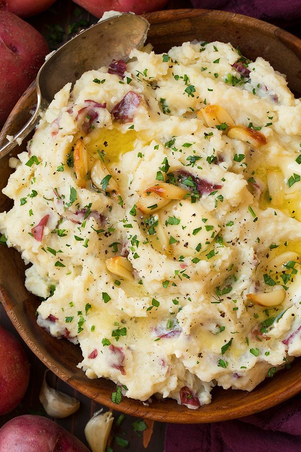 Garlic mashed potatoes in a wooden serving bowl.