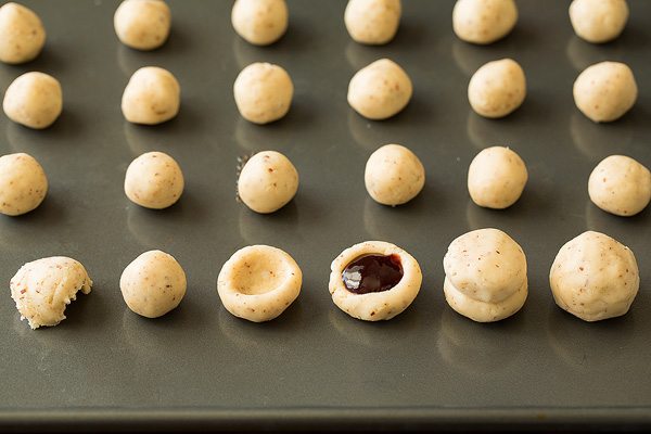 Raspberry Almond Snowball Cookies on a baking sheet before baking.
