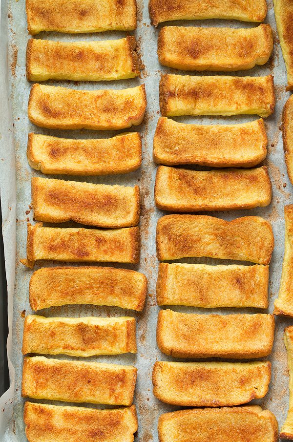 Oven french toast sticks lined up on baking dish