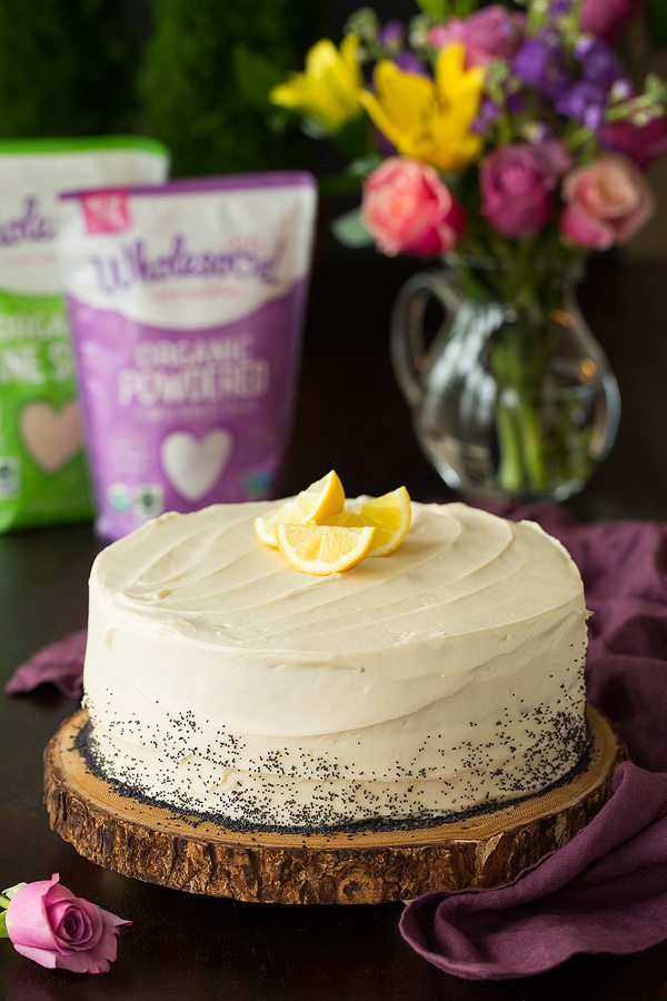 Lemon Poppy Seed Cake with Cream Cheese Frosting on wood board