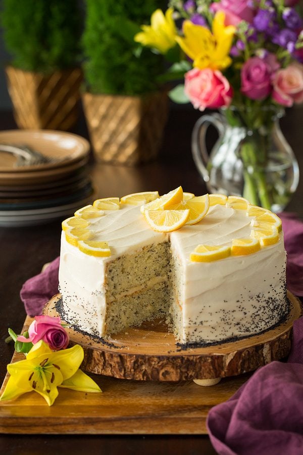 Lemon Poppy Seed Cake with Cream Cheese Frosting on wooden platter