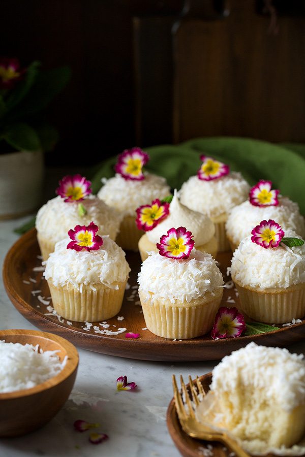 Coconut Cupcakes on wood platter