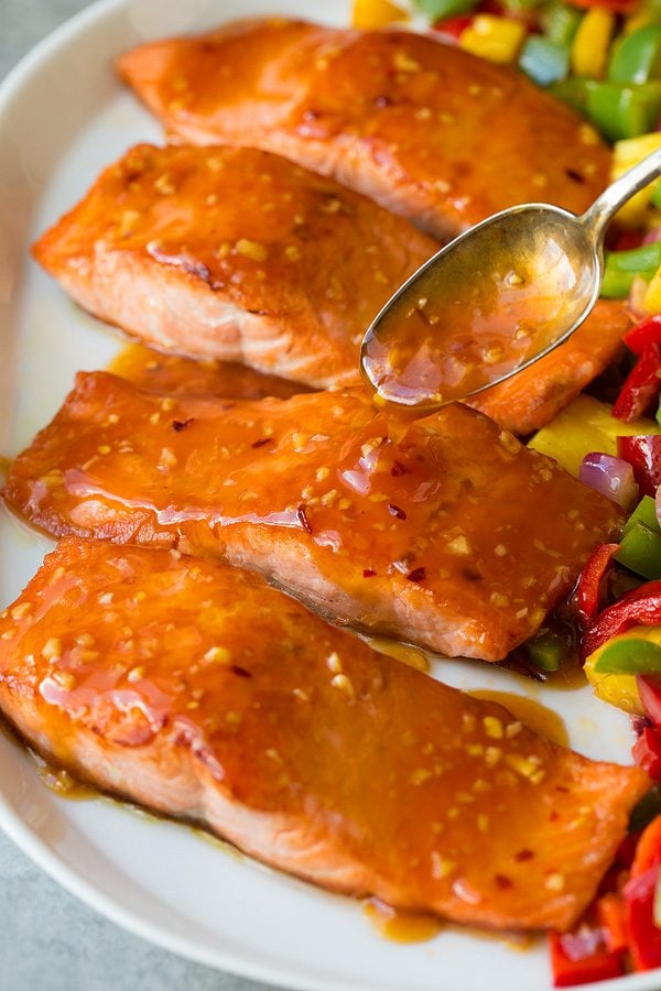 Adding sweet and sour sauce to salmon fillets 