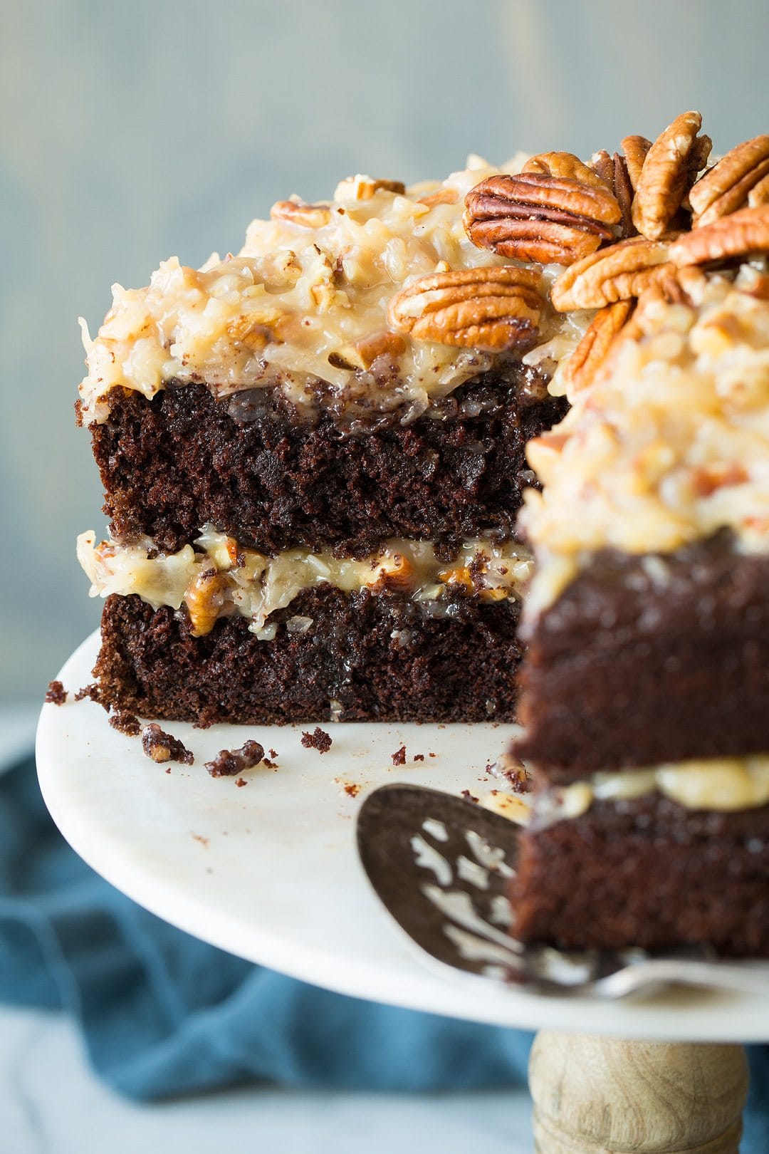 German Chocolate Cake with slice take out. Shown from a side angle.