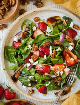 Strawberry Spinach Salad on a plate with balsamic vinegar