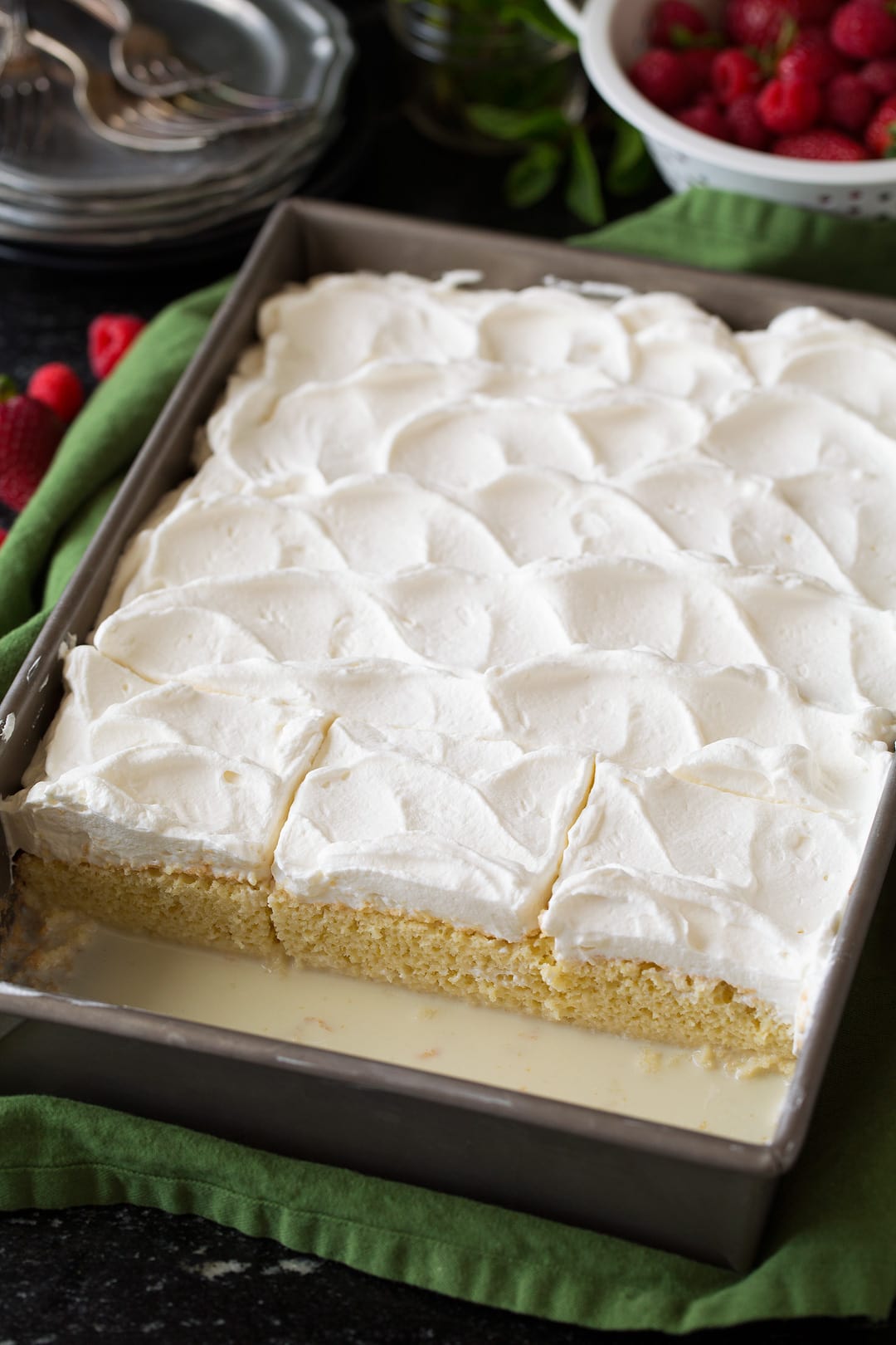 Tres Leches Cake in baking dish, shown after adding whipped cream topping.
